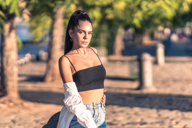 Portrait of skinny young caucasian woman posing in a park