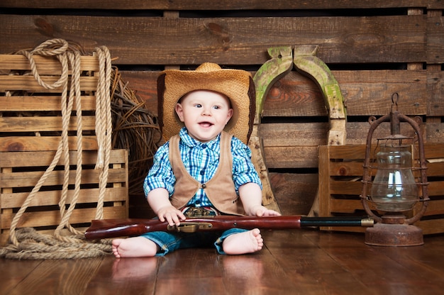 Portrait of a small boy in cowboy decor