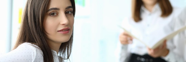 Portrait of smart businesswoman sitting at modern workplace