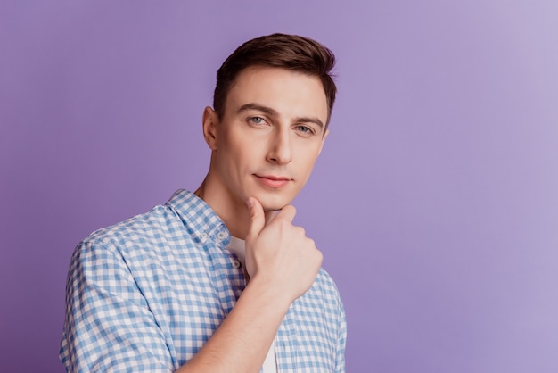 Portrait of smart clever businessman guy finger chin look camera on purple background