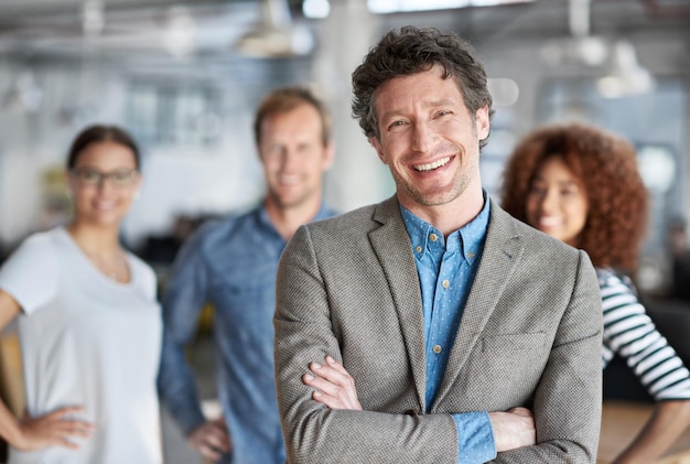 Photo portrait smile and ceo man with arms crossed in office for company collaboration and startup business executive team and diversity in workplace for project management leadership and pride