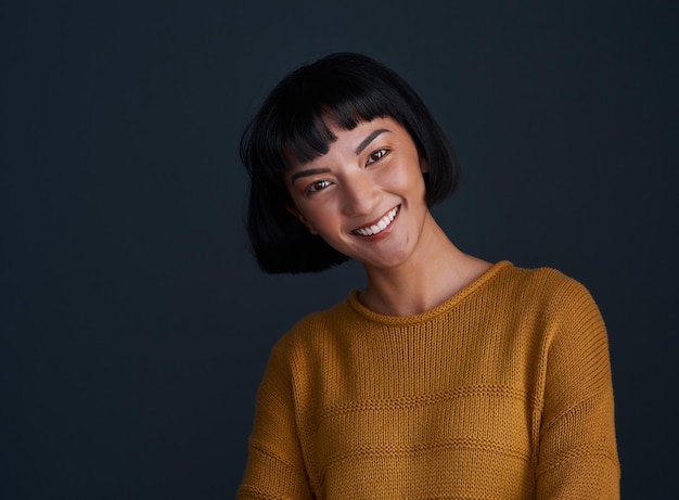 Portrait smile and woman in studio for hair care isolated on black background mockup space Face happy girl and confident hairdresser at salon for beauty cosmetics fashion and hairstylist in Spain