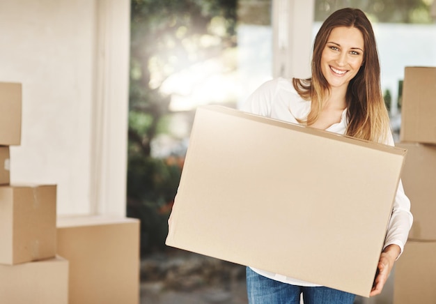 Photo portrait smile and woman with moving box to new home real estate and homeowner for investment of property happy female person and cardboard for mortgage sale or relocation of house