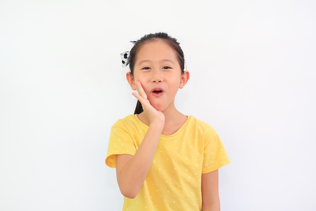 Portrait of smiling Asian little child girl isolated on white background Kid looking at camera and hand touching on cheek