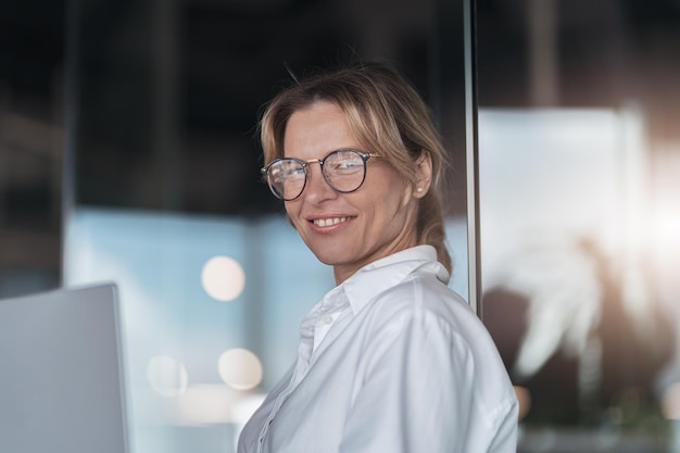 Portrait of smiling beautiful business woman working in modern it office