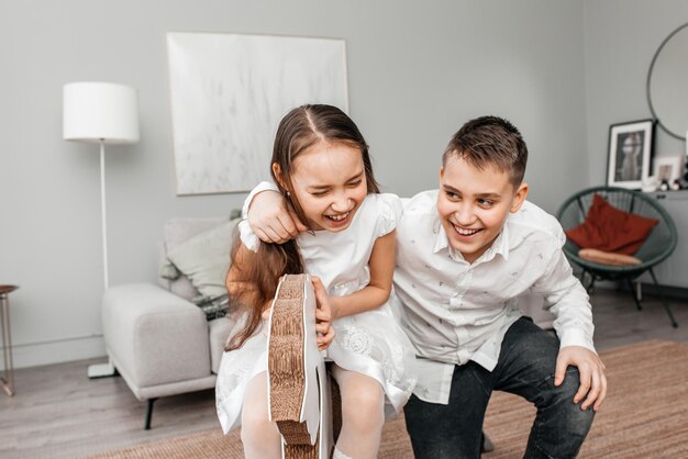 Portrait of a smiling brother hugging his sister sitting on a swing