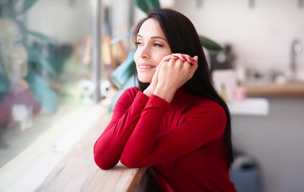 Portrait of smiling brunette woman with red nails