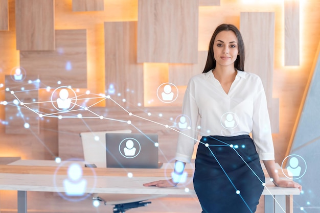 Portrait of smiling businesswoman in formal wear looking for employees and thinking how to hire new candidates for international business consulting HR networking icons over office background