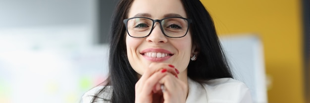 Portrait of a smiling businesswoman wearing glasses business assistant concept