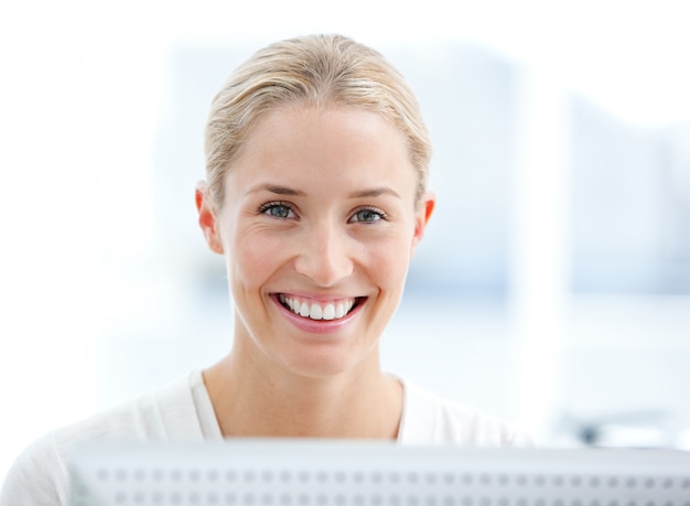 Portrait of a smiling businesswoman working at a computer