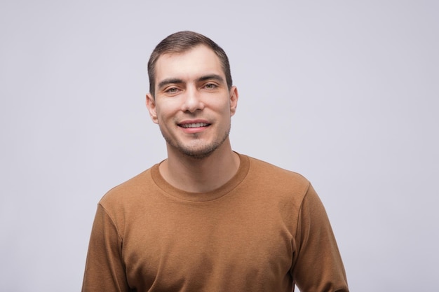 Portrait of smiling caucasian man in beige brown jacket on light grey background mockup copy space