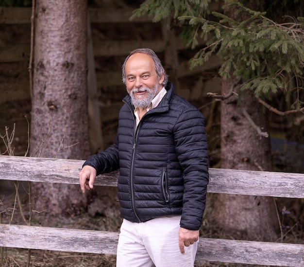 Portrait of a smiling confident handsome mature man looking at the camera walking senior active