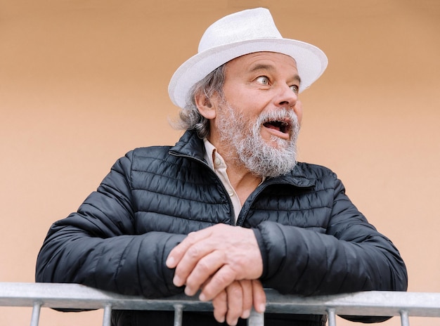 Portrait of a smiling confident handsome mature man near his house senior AntiAging