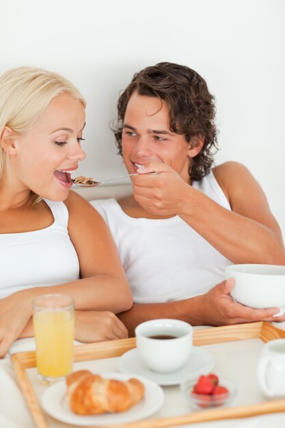 Portrait of a smiling couple eating breakfast