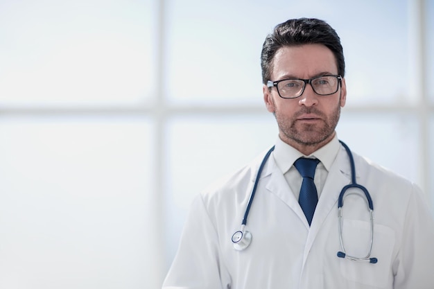 Portrait of a smiling doctor in a bright room of the clinic.photo with text space