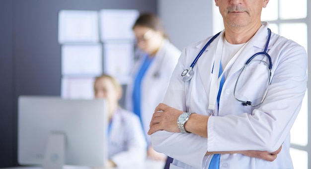 Portrait of a smiling doctor in his bright office