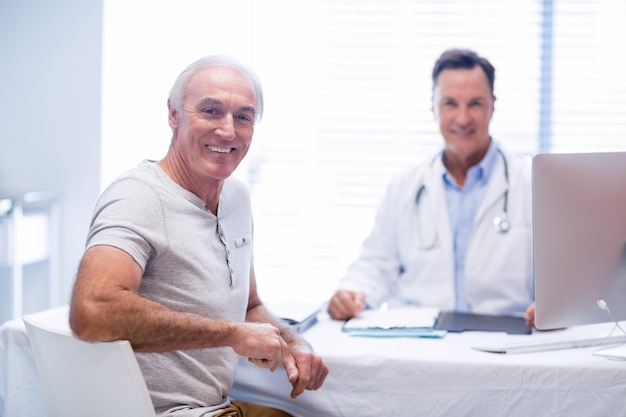 Portrait of smiling doctor and senior man