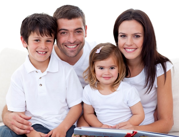 Portrait of a smiling family reading a book