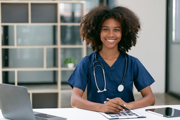 Portrait Of Smiling Female Doctor Wearing White Coat With Stethoscope In Hospital Office