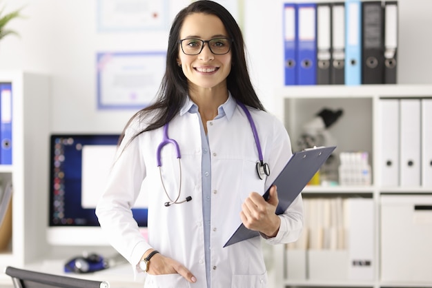 Portrait of smiling female doctor in white coat in medical office