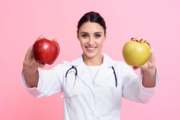 Portrait of smiling female doctor with stethoscope and apple