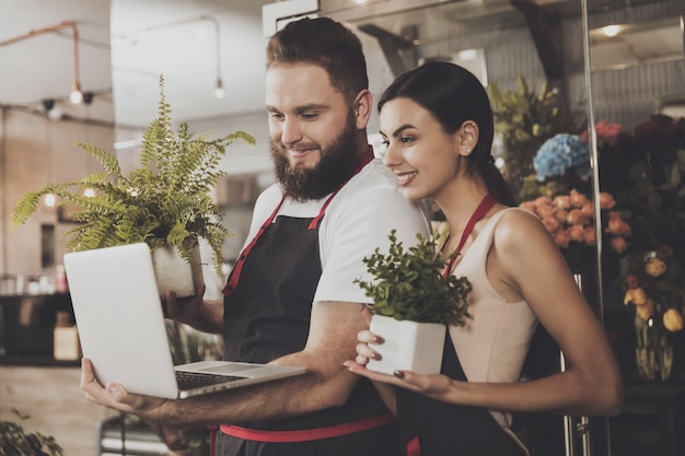 Portrait of smiling florists man and woman