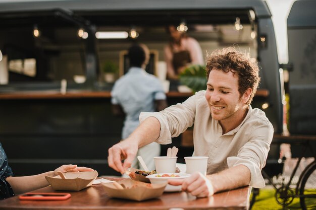 Portrait of smiling friends sitting at restaurant