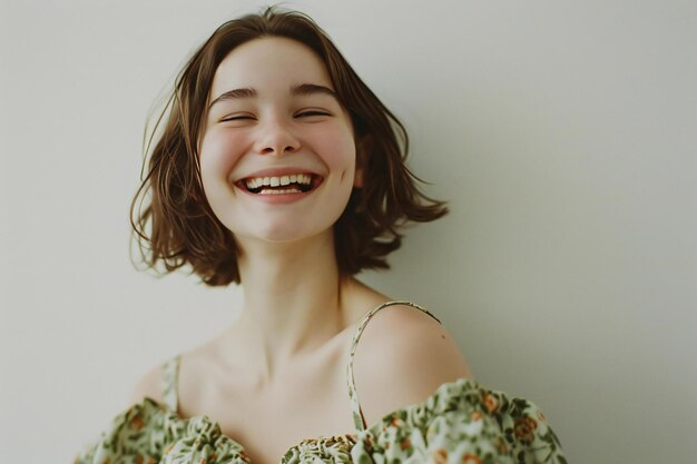 Portrait of a smiling girl in a dress on a white background