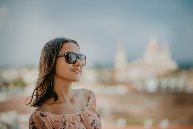 Portrait of a smiling girl in glasses with blurred background of the cathedral of Granada Nicaragua Tourism concept