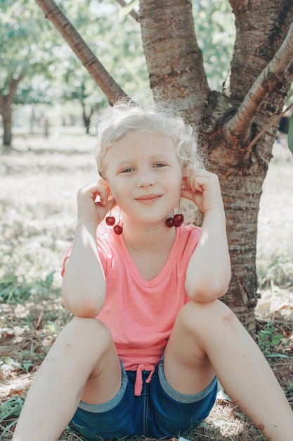 Portrait of smiling girl sitting outdoors