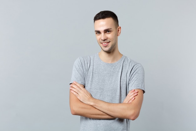 Portrait of smiling handsome young man in casual clothes, holding hands crossed