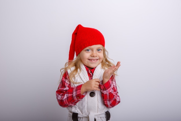 portrait of smiling little blonde girl in Santa hat on white  backgrounds