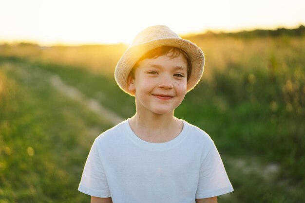 Portrait of a smiling little boy in a white Tshirt raising his hands up and playing