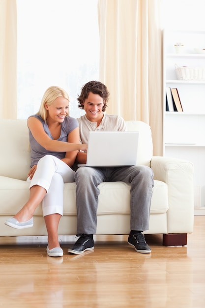 Portrait of a smiling in love couple using a laptop