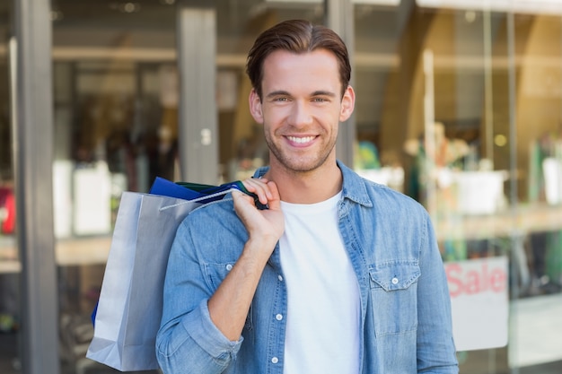 Portrait of a smiling man with shopping bags