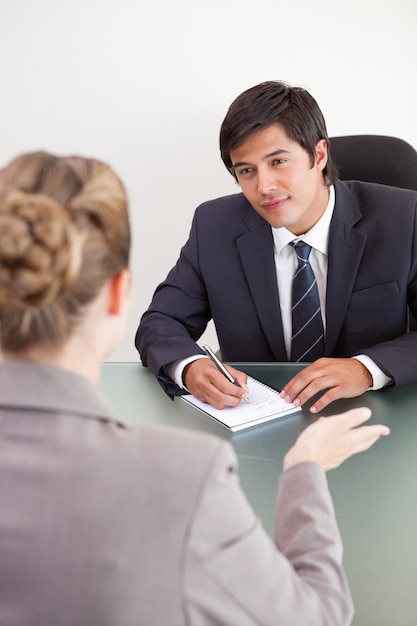 Portrait of a smiling manager interviewing a female applicant