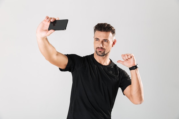 Portrait of a smiling mature sportsman taking a selfie