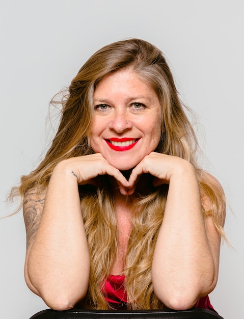 Portrait of smiling middle-aged woman on white background