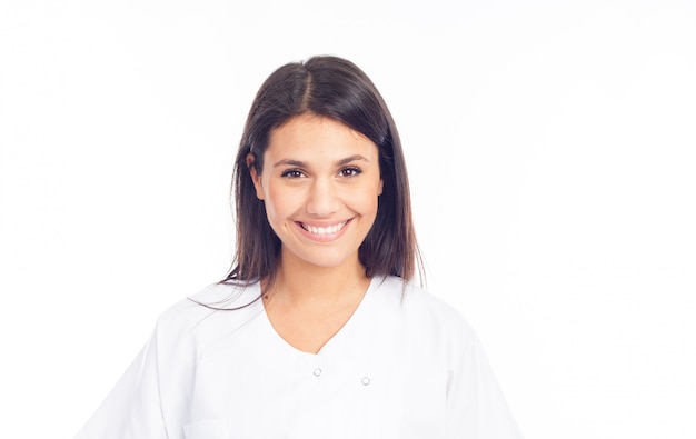 Portrait of smiling nurse or brunette doctor in white coat