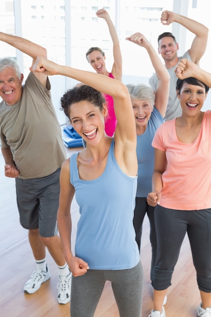 Portrait of smiling people doing power fitness exercise