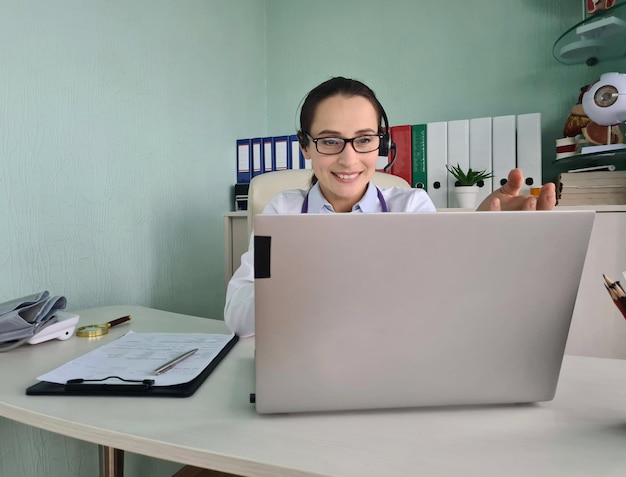 Portrait of smiling professional female doctor in headphones and uniform