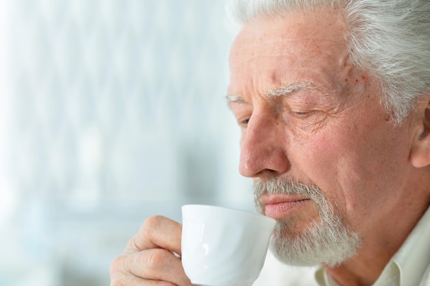 Portrait of smiling senior man drinking coffee