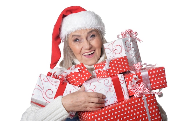 Portrait of smiling senior woman in Santa hat posing