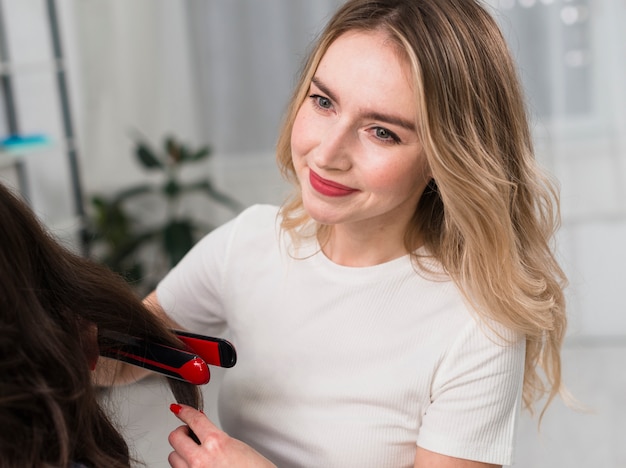 Portrait of smiling stylist woman with client 