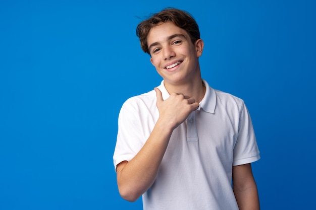 Portrait of a smiling teen boy against blue background