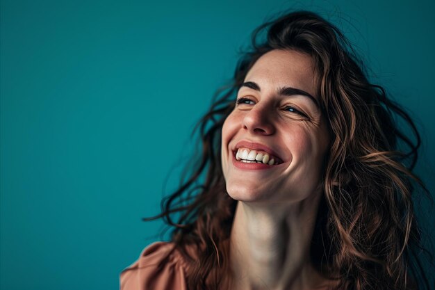 Portrait of a smiling woman against a blue background stock photo