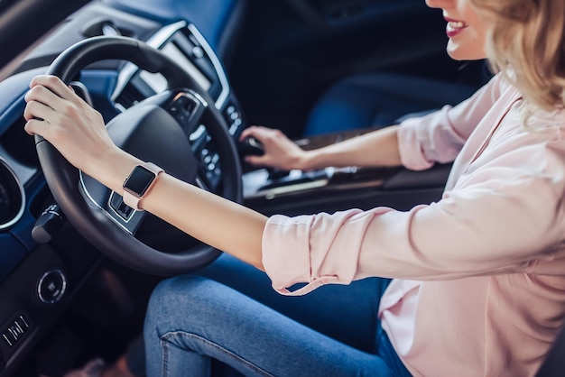 Portrait of smiling woman driving new car