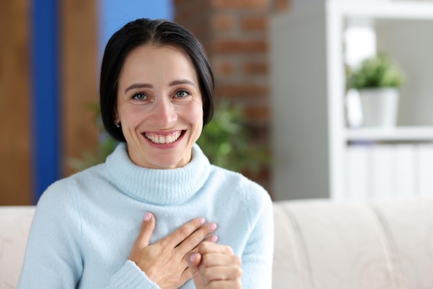 Portrait of smiling woman looking at camera with happiness female showing supportive gesture