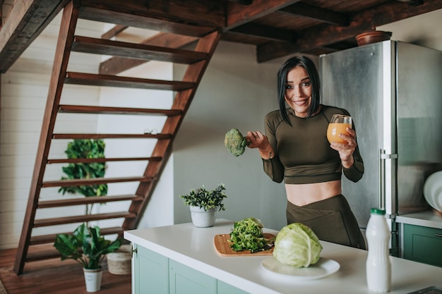 Photo portrait of smiling woman standing by potted plants