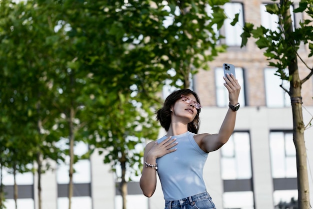 Portrait of a smiling woman taking a selfie